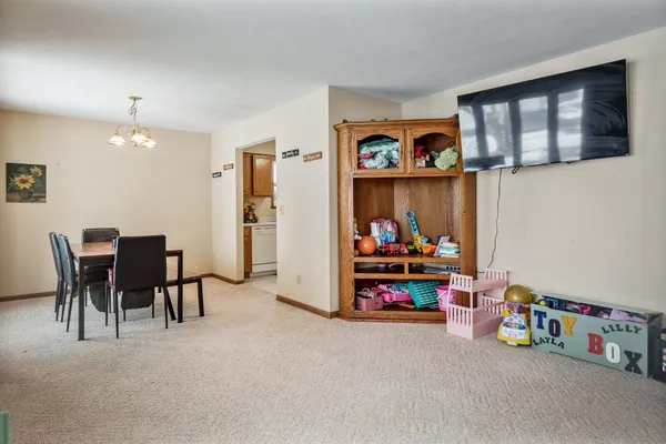 a view of a livingroom with furniture and a large window
