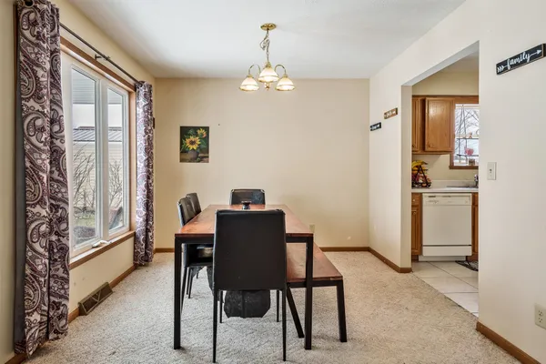 a kitchen with a sink and chairs
