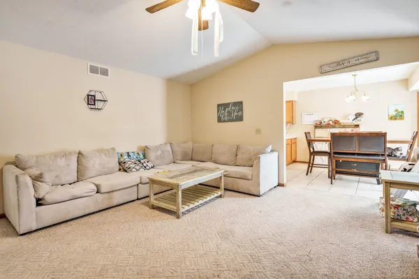 a living room with furniture and a fireplace