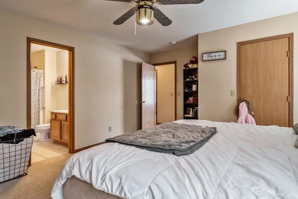 a bedroom with a bed and a dresser in it