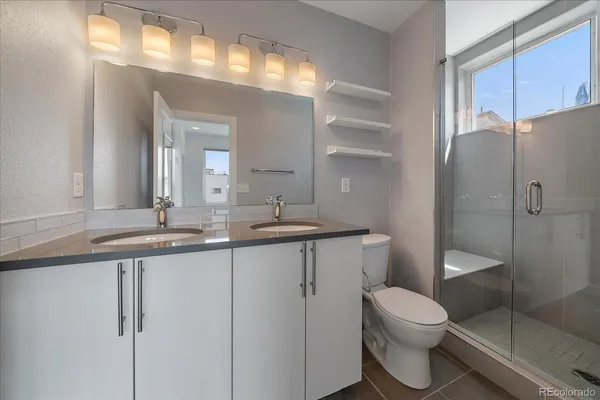 a bathroom with a toilet sink and shower