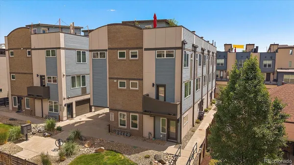 a front view of a residential apartment building with a yard