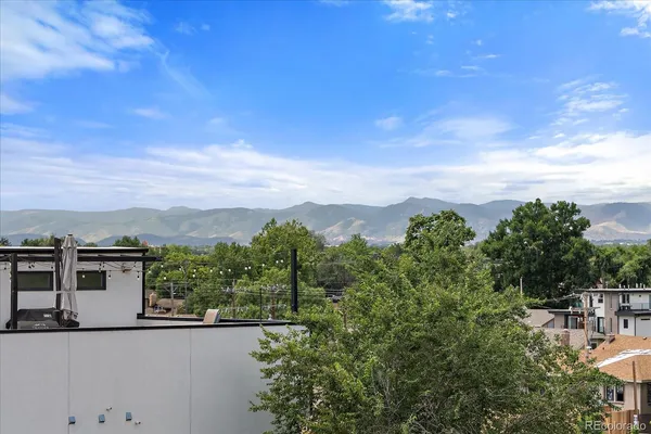 a view of a terrace with a garden and mountain view