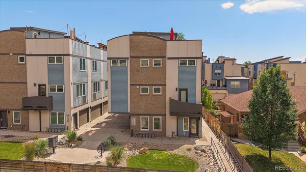 a front view of a residential apartment building with a yard
