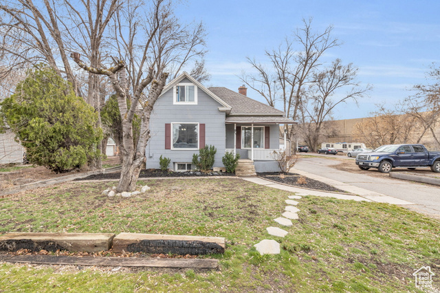 593 West 1020th Street South Provo, UT 84601 - Photo 1 of 1 Bungalow with a front lawn, covered porch, roof with shingles, and a chimney