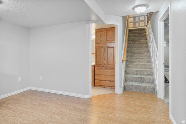 860 West 2980th Street South Logan, UT 84321 - Photo 25 of 38 Staircase with carpeted treads and white risers, featuring a wood handrail