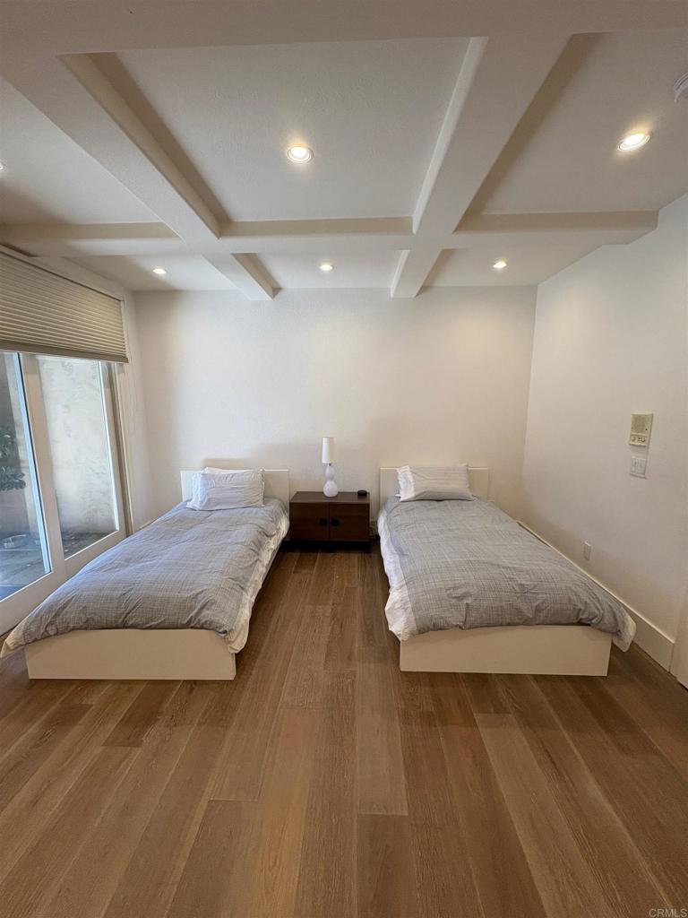1317 Caminito Balada La Jolla, CA 92037 - Photo 14 of 16 a spacious bedroom with a bed and a table