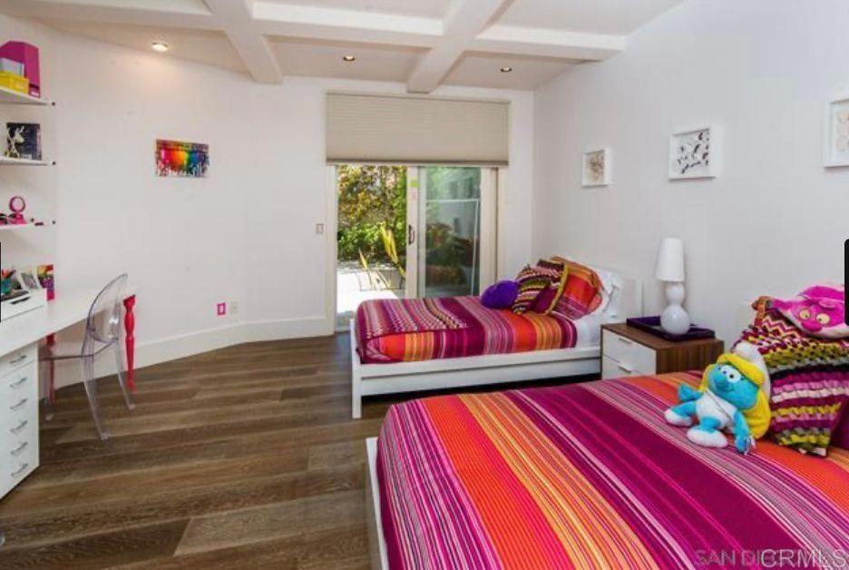 1317 Caminito Balada La Jolla, CA 92037 - Photo 15 of 16 a bedroom with furniture and a wooden floor