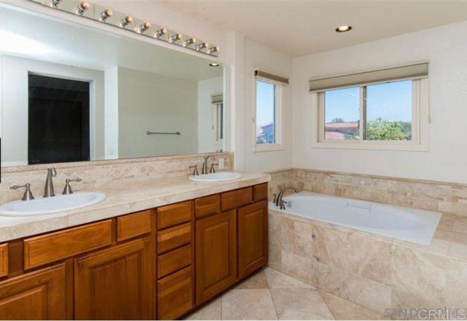 1317 Caminito Balada La Jolla, CA 92037 - Photo 9 of 16 a bathroom with a tub sink and mirror