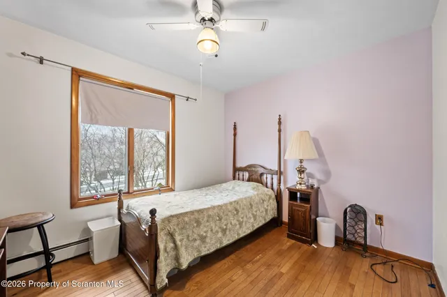 a bathroom with a sink a toilet a mirror and shower