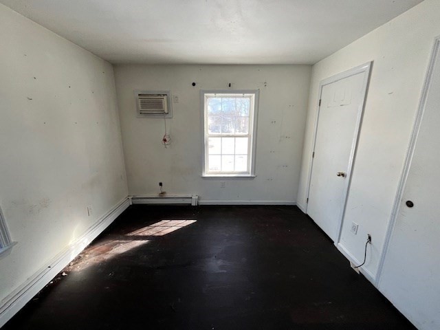 399 Main Street Oxford, MA 01540 - Photo 11 of 28 an empty room with wooden floor and windows
