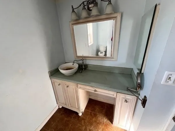 a bathroom with a sink a mirror and bathtub