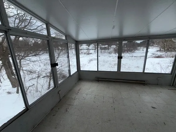 a view of an empty room with large windows