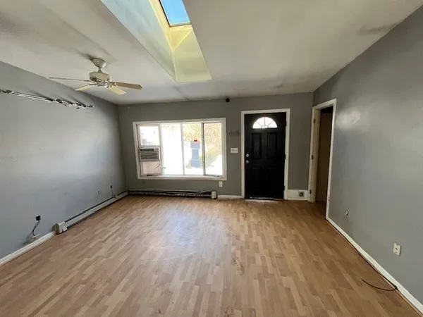 wooden floor in an empty room with a window
