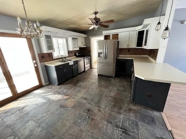 a large kitchen with cabinets and stainless steel appliances