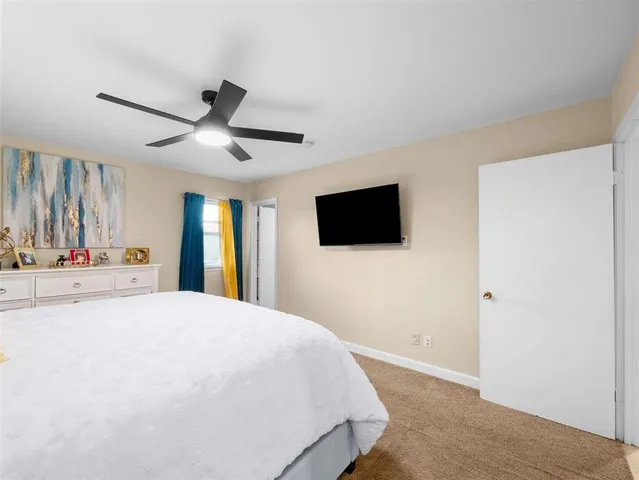 a bathroom with a toilet sink vanity granite and mirror