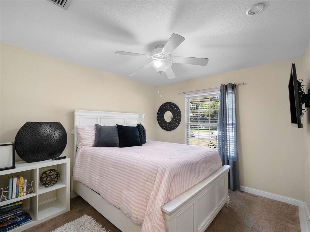 3750 Ridgeoak Way Farmers Branch, TX 75244 - Photo 20 of 30 a bedroom with a bed and a chandelier