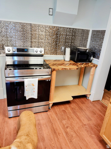 5264 West 5500th Street South Hooper, UT 84315 - Photo 9 of 20 Kitchen with electric stove, light wood-type flooring, wooden counters, and tile walls
