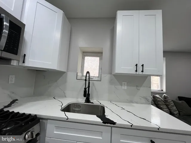 a kitchen with a sink and cabinets