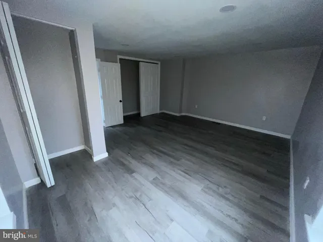 a view of a pathway of a house with wooden fence