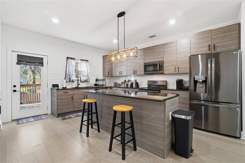 2281 Pryor Road Southwest Atlanta, GA 30315 - Photo 13 of 32 a kitchen with refrigerator and chairs