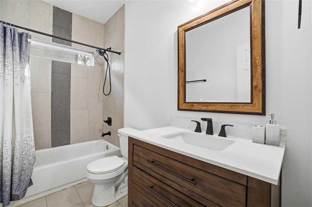 2281 Pryor Road Southwest Atlanta, GA 30315 - Photo 17 of 32 a bathroom with a sink vanity mirror toilet and bathtub
