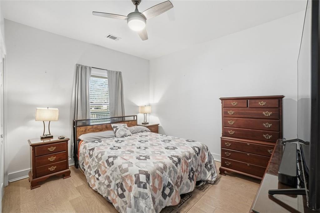 2281 Pryor Road Southwest Atlanta, GA 30315 - Photo 18 of 32 a bedroom with a bed and a chandelier