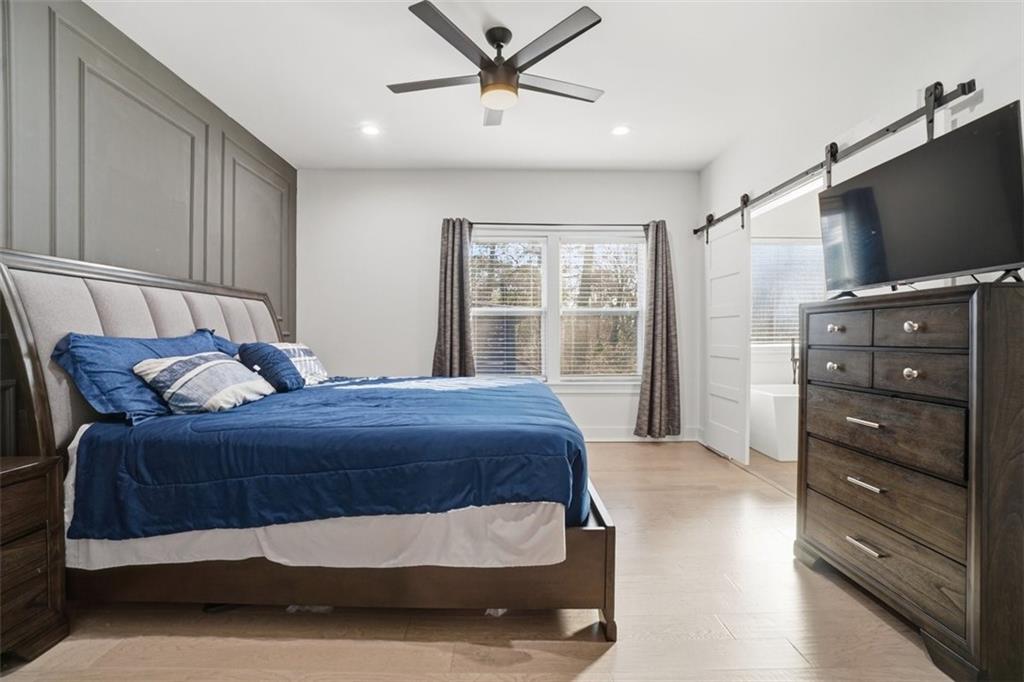 2281 Pryor Road Southwest Atlanta, GA 30315 - Photo 21 of 32 a bedroom with a bed and a flat screen tv