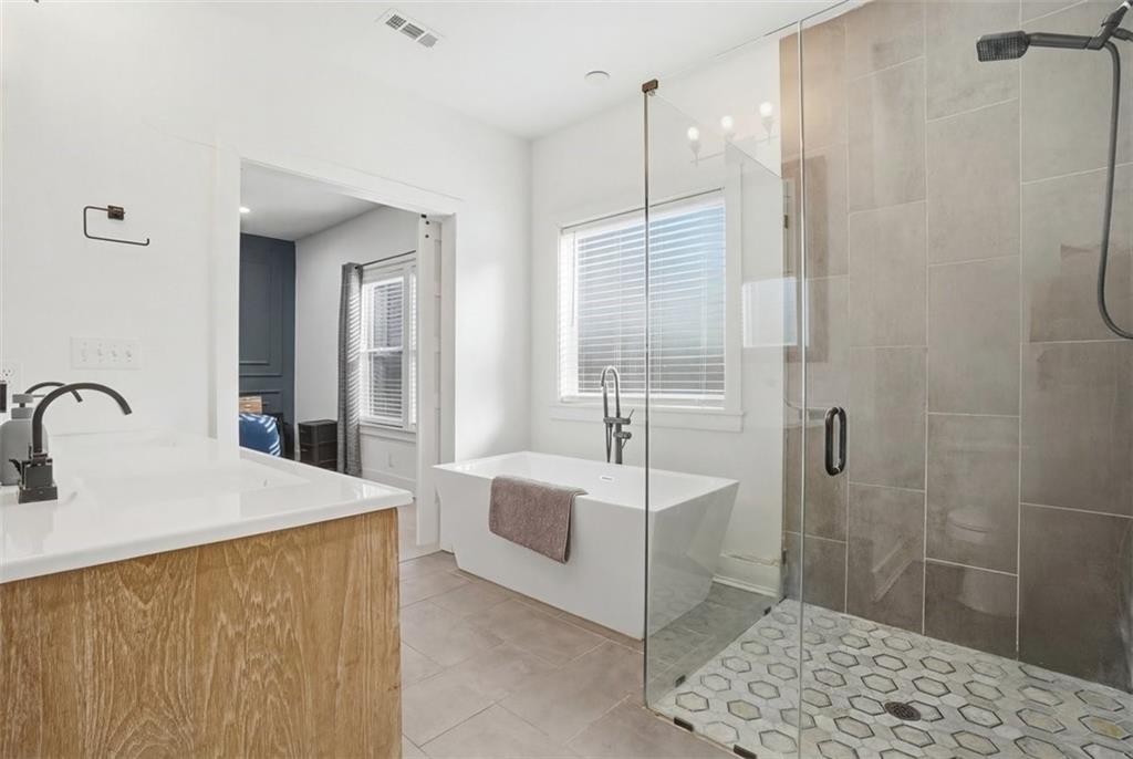 2281 Pryor Road Southwest Atlanta, GA 30315 - Photo 26 of 32 a spacious bathroom with a double sink shower and a mirror