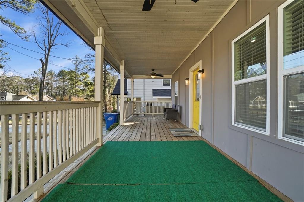2281 Pryor Road Southwest Atlanta, GA 30315 - Photo 4 of 32 a view of a porch with wooden floor and outdoor seating