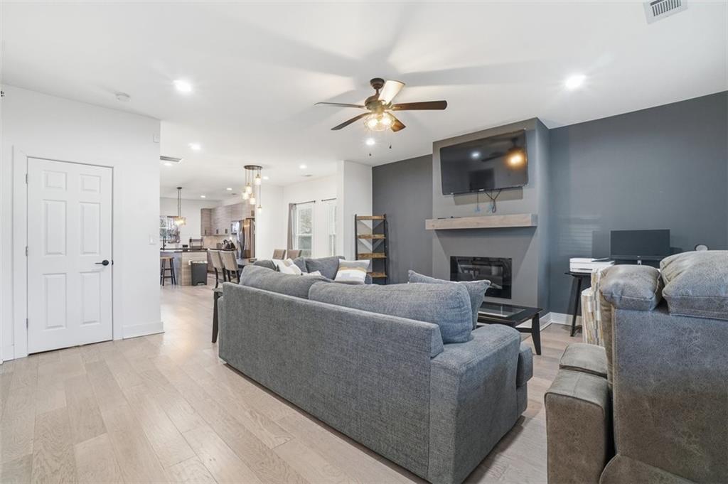 2281 Pryor Road Southwest Atlanta, GA 30315 - Photo 6 of 32 a living room with furniture a fireplace and a ceiling fan