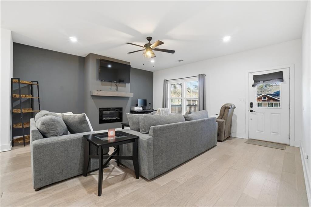 2281 Pryor Road Southwest Atlanta, GA 30315 - Photo 7 of 32 a living room with furniture a flat screen tv and a fireplace
