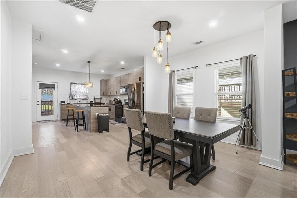 2281 Pryor Road Southwest Atlanta, GA 30315 - Photo 10 of 32 a kitchen with stainless steel appliances kitchen island granite countertop a table chairs and a refrigerator