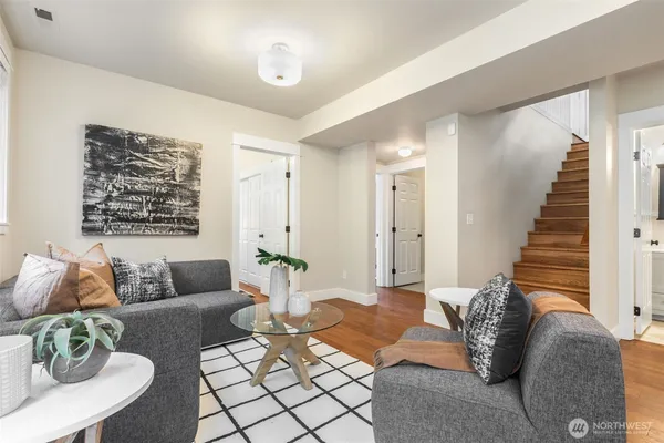 a living room with furniture and wooden floor