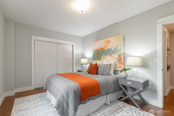 a bedroom with a bed and a painting on the wall