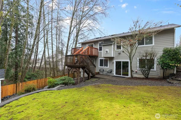 a view of a house with a patio and a yard