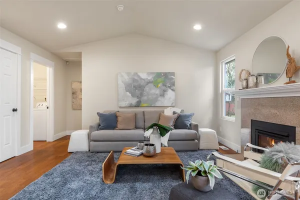 a living room with furniture and a fireplace