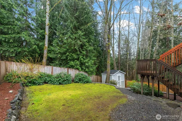 a view of a backyard with stairs and garden