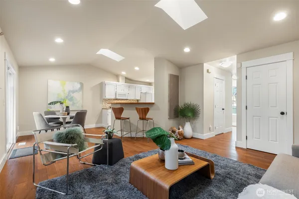 a living room with furniture and a wooden floor