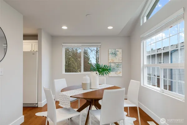 a view of a dining room with furniture and a potted plant