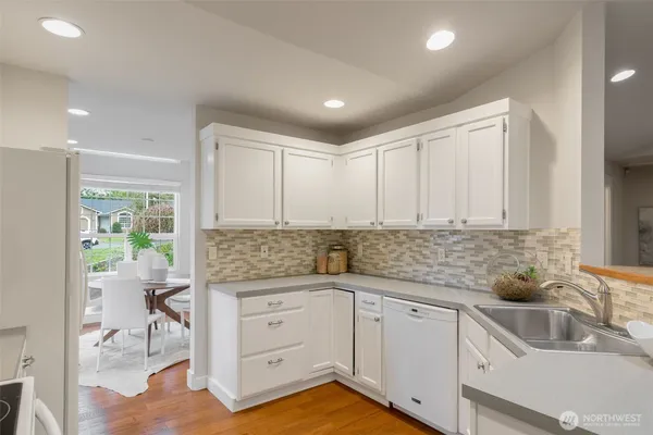a kitchen with a sink window and cabinets