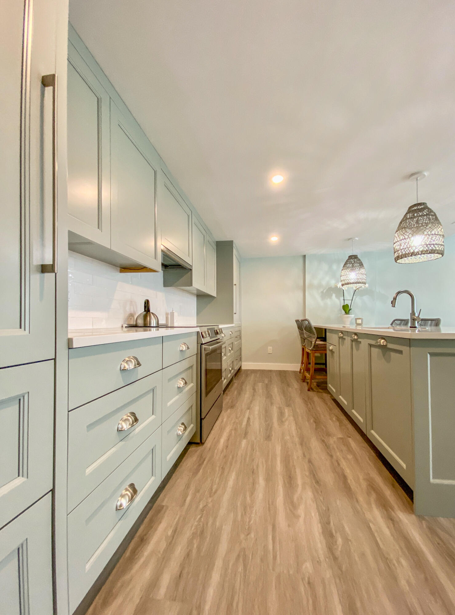 1 Belmont Road, Unit 225 West Harwich, MA 02671 - Photo 4 of 31 a kitchen with stainless steel appliances kitchen island granite countertop a lot of cabinets and wooden floor