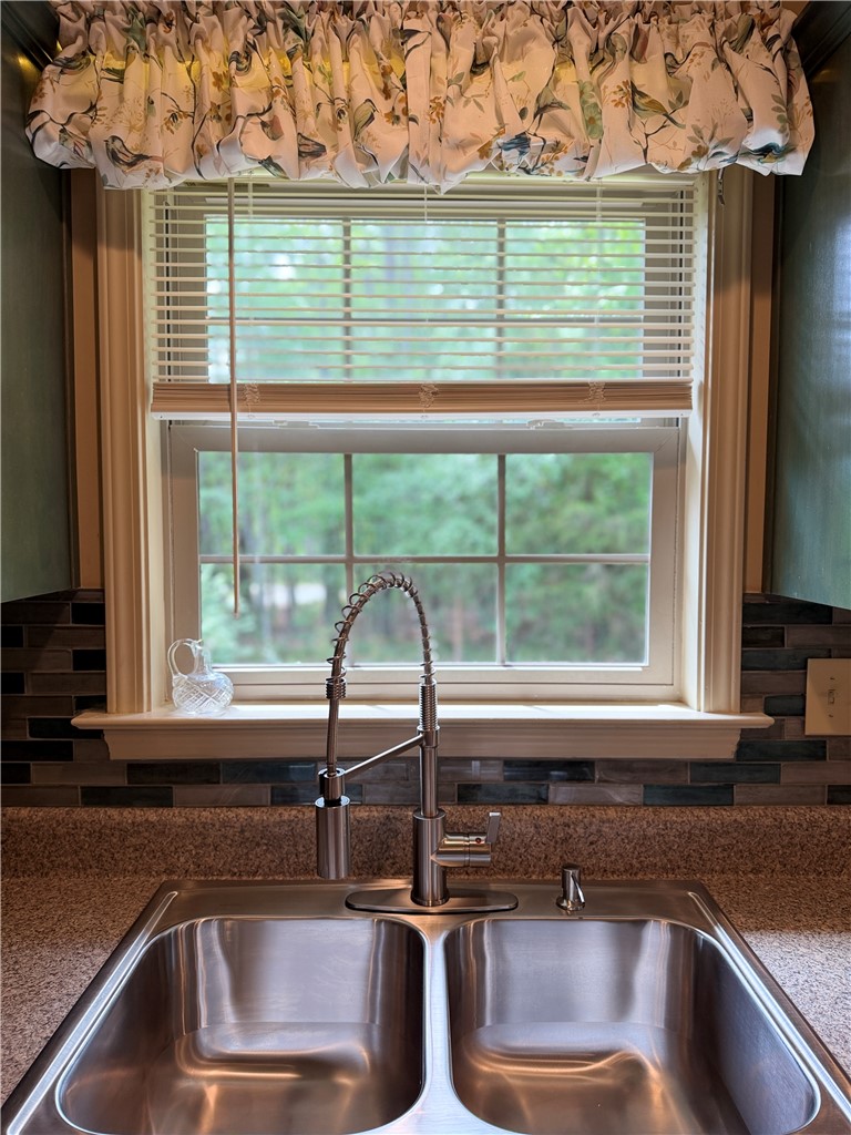 232 Hunters Trail Walhalla, SC 29691 - Photo 13 of 38 A well-appointed kitchen features a dual basin sink and a view of lush greenery.