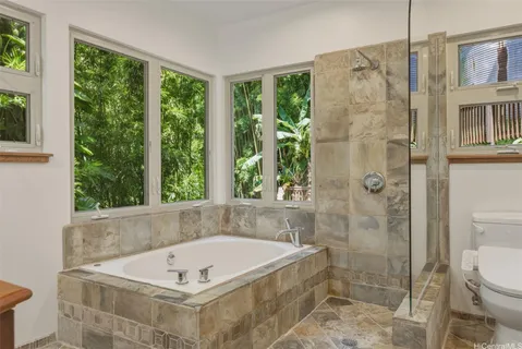 a bath tub sitting in a bathroom next to a window