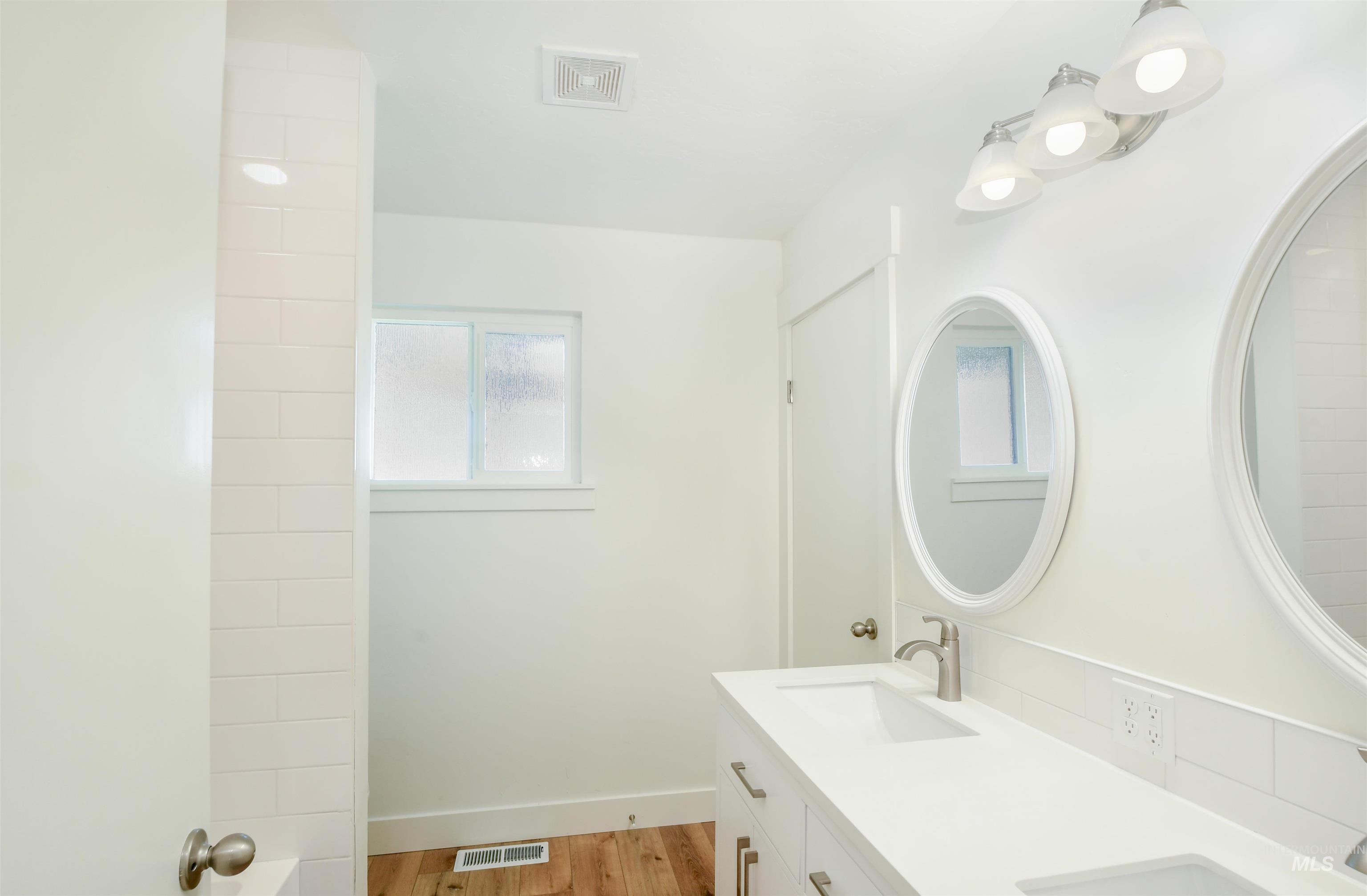 8481 Big Foot Road Melba, ID 83641 - Photo 15 of 41 Bathroom with light wood finished floors and double vanity