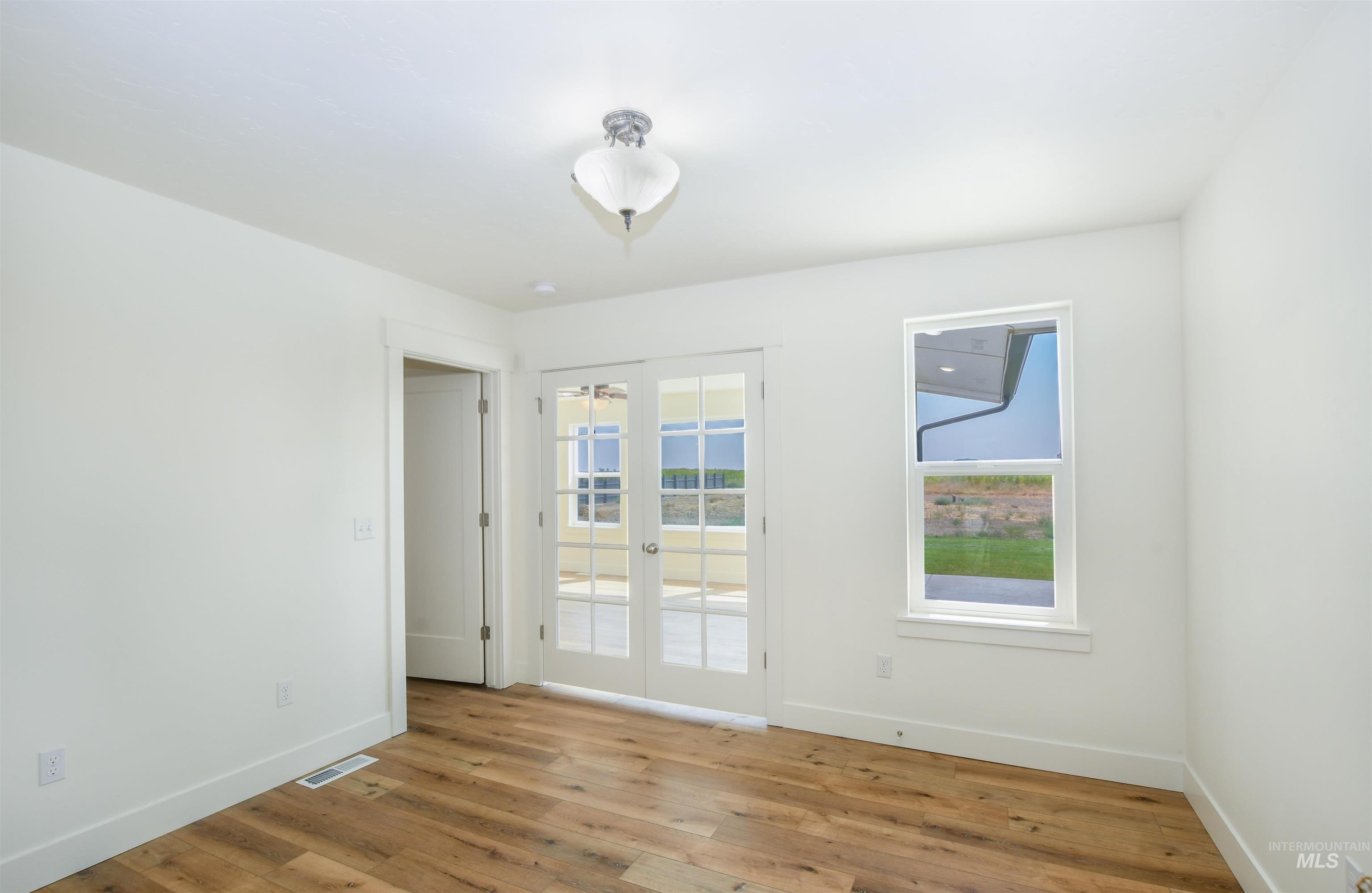 8481 Big Foot Road Melba, ID 83641 - Photo 17 of 41 Spare room featuring baseboards and light wood-type flooring