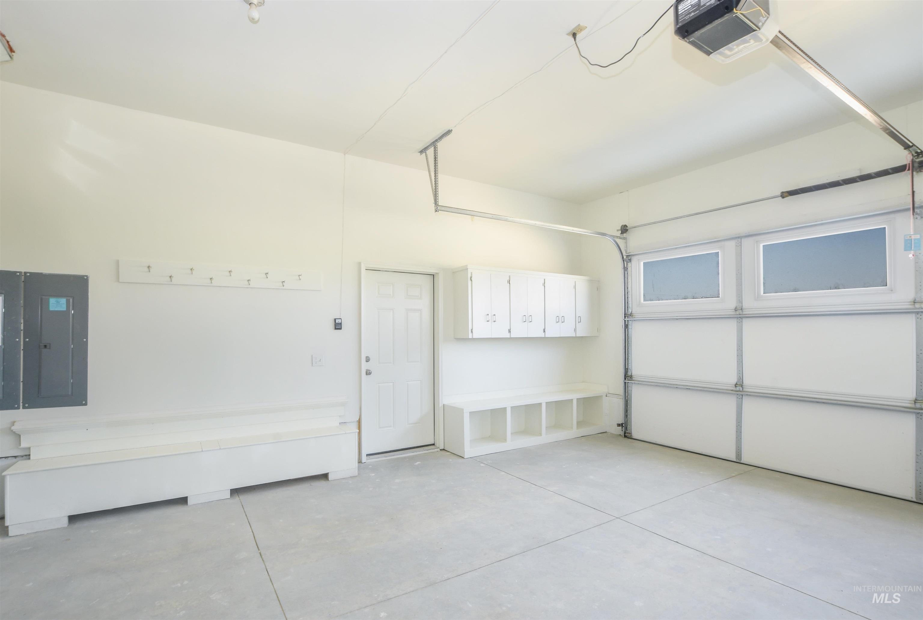 8481 Big Foot Road Melba, ID 83641 - Photo 30 of 41 Garage featuring a garage door opener and electric panel