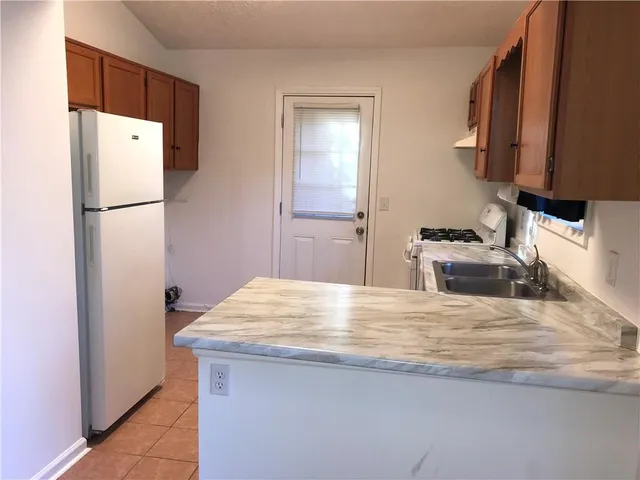 a kitchen with stainless steel appliances a refrigerator and a sink
