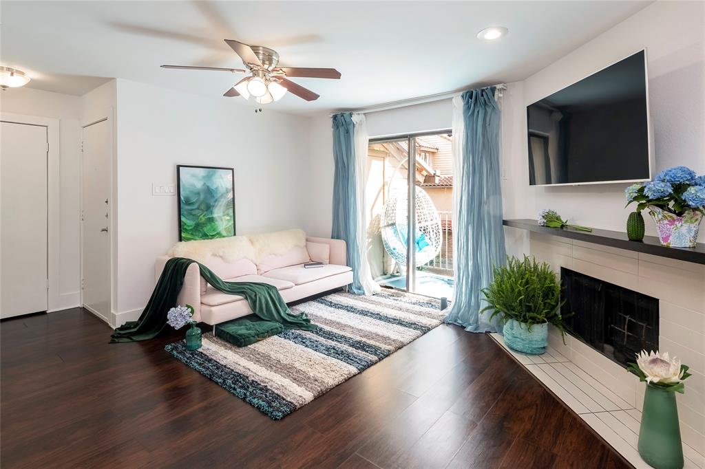 a living room with furniture fireplace and flat screen tv