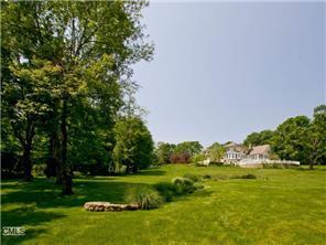 172 Umpawaug Road Redding, CT 06896 - Photo 1 of 1 a view of a golf course with a lake